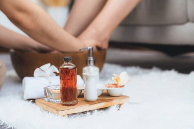 Spa aksesuarları, müşterilerin lüks spa salonlarında keyifli ayak masajları yaparken masörlerin gündüz açık ambians kaplıcalarında refleksoloji terapisi yaptıkları bulanık arka plan üzerine kuruludur. Sessiz.