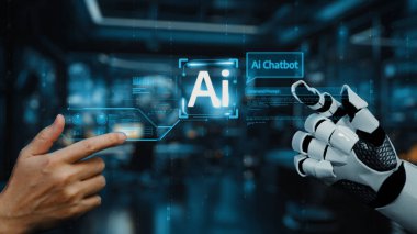 Bir insan eli, yapay zeka sohbet robotu arayüzü gösteren robot eliyle etkileşime girer. Bu da gelecekteki teknolojiyi ve iletişim ve otomasyondaki yeniliği gösterir. Auvana