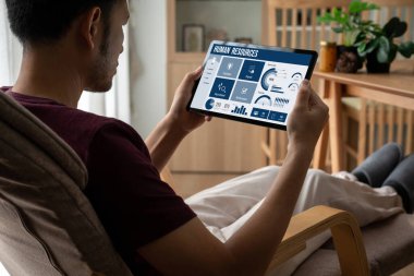 Human resources management software on computer screen helping human resources employee to manage recruitment, payroll, staff searching and KPI evaluation snugly