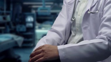 Profesyonel doktorun oturduğu ve DNA örneği hologramının hastanede bulanık bir şekilde yüzdüğünü gösteren bir fotoğraf. Sağlık çalışanı DNA teknolojisini kontrol ediyor ve genetik bozuklukları inceliyor. İyileştirici.