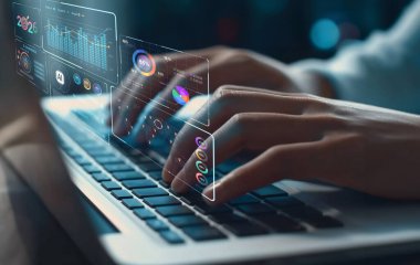 Dijital analitik ve veri görselleştirmeleri ile tamamlanmış ve yapay zekanın önümüzdeki yıl için pazarlama stratejilerine entegrasyonunu vurgulayan bir dizüstü bilgisayarda yazı yazan ellerin yakın plan görüntüsü. XDMCP