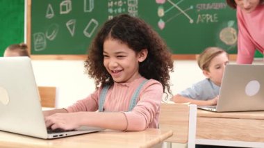 Çekici kız kodlama hızlı BTMM sınıfında kameraya bakarken mutlu öğretmen akıllı çocuk yazılım programını kontrol ediyor. Programlama kodu ve bilgisayar sistemi üzerine çeşitli öğrenci çalışmaları. Pedagoji.