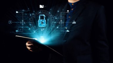 Takım elbiseli bir işadamı, modern dünyada veri koruması ve siber güvenliğin önemini temsil eden dijital bir güvenlik kilidinin resimli tabletini elinde tutuyor. Dörtgen