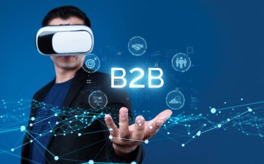 İş adamı B2B peyzajında geziniyor, iş-iş bağlantılarını geliştirmek için kullanım teknolojisi kullanıyor. B2B etkileşimlerini yeniden şekillendirir, iş-iş stratejilerinde yenilikleri teşvik eder. FaaS