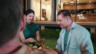 Family together for holiday celebration in garden. Family member gather have dinner. Outdoor picnic activity to relax with food and spend time with cute relatives cross generation gap. Divergence.