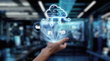 Bir el, veri transferini sembolize eden bir buluta uzanıyor, modern dijital çalışma alanında depolama, işleme ve iletişimi temsil eden ikonlar sergiliyor. Auvana