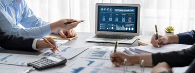 İş zekası ve veri analizi kavramı. Analizci ekibi laptop ekranında finansal veri analizi üzerinde çalışıyor. Etkili iş stratejik planlama için pazarlama göstergesi olarak. İçgörü