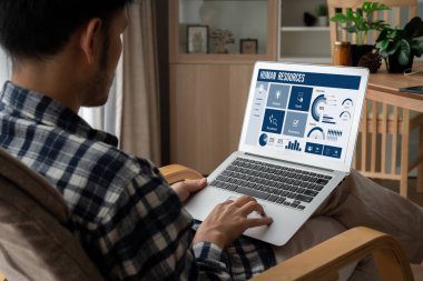 Human resources management software on computer screen helping human resources employee to manage recruitment, payroll, staff searching and KPI evaluation snugly