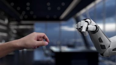 Bir insan eli ve robotik el, modern bir çalışma alanındaki teknoloji ve insan etkileşiminin karışımını gösteren dijital bir finans grafiği üzerinden bağlanmaya hazırdır. Auvana