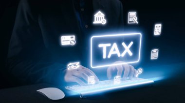 Üzerinde neon vergisi grafikleri olan bir klavyede yazan eller, teknolojinin dijital çağda vergi hazırlama ve mali yönetime entegrasyonunu gösteriyor. Dörtgen