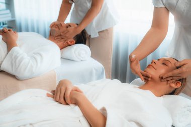 Kafkasyalı çift stres önleyici kafa masajının keyfini çıkarıyor ve lüks otellerde ya da otel spa salonlarında gündüz kaplıcalarında yüz güzelliği eğlencelerini şımartıyor. Sessiz.