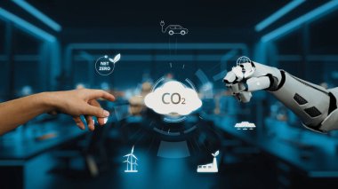 Modern ofis ortamında bir insan eli robotik kola uzanıyor, bu da teknoloji ile CO2 emisyonlarını azaltmada sürdürülebilirlik arasındaki işbirliğini simgeliyor. Auvana