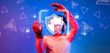 Siber güvenlik ve veri gizliliğinin dinamik dünyasını sanal bir kalkan tasvir eden ve teknolojide çevrimiçi koruma ve güvenliği temsil eden görsel elemanlarla keşfedin. XDMCP