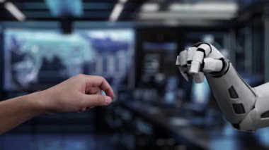 Bu video insan elinin robot ele doğru uzanmasını gösteriyor, modern teknolojik bağlamda yapay zeka ile etkileşimi ve iletişimi sembolize ediyor. Auvana