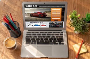 car rental website on computer screen for tourist to rent a car for transportation snugly