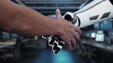 İnsan eliyle robotik kol arasındaki etkileşimi gösteren kavramsal video modern çalışma alanındaki teknolojik güncellemeleri ve dijital ilerlemeyi gösteriyor. Auvana