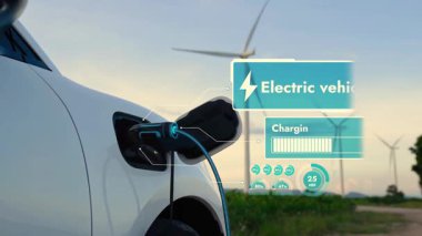 Elektrikli araba, EV şarj istasyonundan enerji alıyor. Rüzgar türbini çiftliğinde EV şarj kablosu kablosunun fütüristik akıllı batarya durum hologramını gösteriyor. Alternatif temiz enerji sürdürülebilirliği. İnceleyin