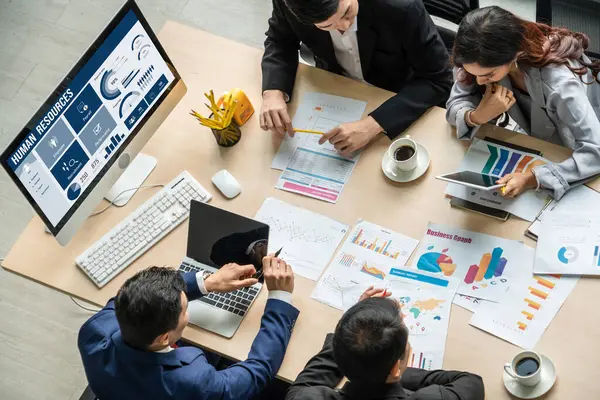 Human resources management software on computer screen helping human resources employee to manage recruitment, payroll, staff searching and KPI evaluation snugly