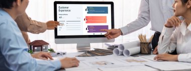 İç mimar tasarımcı grubu, daha kesin tasarım için planlar ve dizüstü bilgisayar ekran mimari yazılımı üzerinde birlikte tartışıyorlar. Modern ev tasarımı ve yenileme. İçgörü