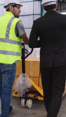 Fabrika işçileri depodaki bir yük arabasında kutu teslimatı yapıyor. Sanayi tedarik zinciri yönetim kavramı .