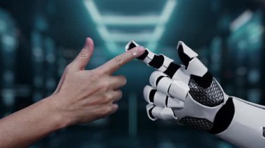 İnsan eliyle robotik kol arasındaki etkileşimi gösteren kavramsal video modern çalışma alanındaki teknolojik güncellemeleri ve dijital ilerlemeyi gösteriyor. Auvana