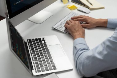 Bilgisayarda bilgisayar ve bilgisayar üzerinde çalışan ve uygulama projesinde kodlama programı olan bilgisayar geliştiricisinin kırpılmış görüntüsü. Teknik mühendis önemli not listeleri yazıyor. Bireysel.