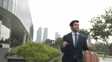 Keyifle dans eden yetenekli beyaz iş adamı soğukkanlılığını koru ve şehir merkezinde yürümeye devam et. Profesyonel menajer terfi ile ilgili iyi haberleri kutlamak için dans ediyor. Sevinçli..