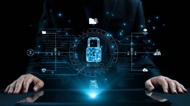 Bir iş adamı canlı dijital güvenlik unsurlarıyla etkileşime girer, çağdaş bir çalışma alanında veri güvenliği ve yenilikleri vurgulayarak siber güvenlik gelişimlerini vurgular. Dörtgen