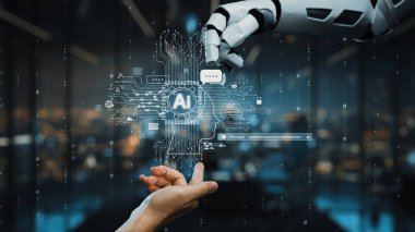 İnsan ve robot eller arasındaki etkileşimi gösteren çarpıcı bir görüntü, modern iletişim ve yenilikteki yapay zeka ve teknoloji rolünü sembolize ediyor. Auvana