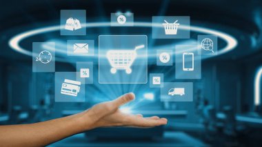 Bir el, yeniliğin ve e-ticarette kolaylığın ve modern bir çalışma alanında çevrimiçi alışverişin yakınlaşmasını sembolize ederek, yüzen dijital alışveriş ikonlarına uzanıyor. Auvana