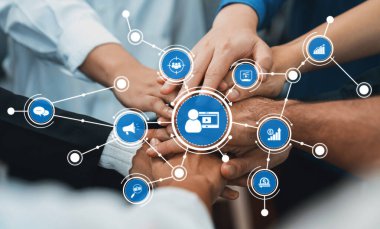 Takım çalışmasının canlı bir temsili, bu resim ellerin bir araya gelişini gösteriyor, dijital pazarlamada yenilikçi grafik simgeleriyle işbirliğini sembolize ediyor. Dostluk