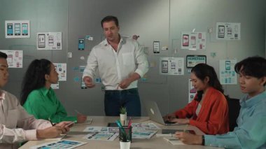 Bir grup profesyonel iş adamı Ux ve Ui tasarımı hakkında konuşuyor. İşbirlikçi çeşitli iş adamları pazarlama planı hakkında beyin fırtınası yapıyor. Birlikte çalışan iş adamları. Yönlendirici.