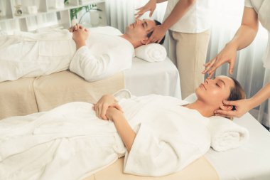 Kafkasyalı çift stres önleyici kafa masajının keyfini çıkarıyor ve lüks otellerde ya da otel spa salonlarında gündüz kaplıcalarında yüz güzelliği eğlencelerini şımartıyor. Sessiz.