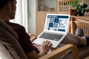 Human resources management software on computer screen helping human resources employee to manage recruitment, payroll, staff searching and KPI evaluation snugly