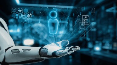 Fütürist bir robot el, modern teknolojik yenilik ve etkileşimi vurgulayan holografik ikonlar ve veri grafikleri de dahil olmak üzere bir dizi dijital arayüz elementi sergiler. Auvana