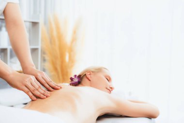 Kafkasyalı kadın müşteri stres önleyici spa masajının keyfini çıkarıyor ve lüks otel ya da oteldeki gündüz açık ortam güzellik salonunda güzellik teniyle eğleniyor. Sessiz.