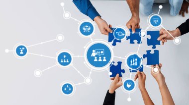 Yapboz parçaları ve dijital simgelerle sorunları çözmek için işbirliği yapan, takım çalışmasını, iletişimi ve yenilikçi düşünceyi dinamik bir ortamda sembolize eden canlı bir resim. Dostluk