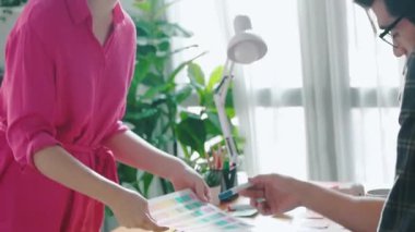 Yetenekli beyaz iş kadını çeşitli yatırımcılara tema rengini sunuyor. Çok kültürlü insanlar toplantı masasında otururken ürünün rengini belirlemek için plan yapıyor ve karar veriyorlar. Sempozyum.