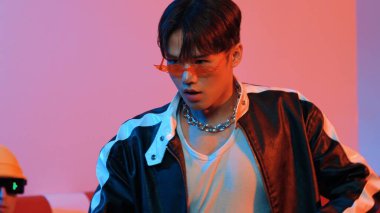 Çekici Asyalı sokak dansçısı neon ışıkla serbest stil hareketi yapıyor. Profesyonel sanatçı, çeşitli arkadaşlarıyla ya da stüdyoda ışık saçan bir ekiple hip hop müzik yapmaya çalışıyor. Mutluluk.