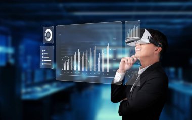 Profesyonel bir adam, finansal planlama için veri ölçümlerini analiz etmek, stratejik pazarlama çabalarını geliştirmek ve bilgilendirilmiş yatırım kararları almak için sanal gerçeklik teknolojisini kullanır. XDMCP