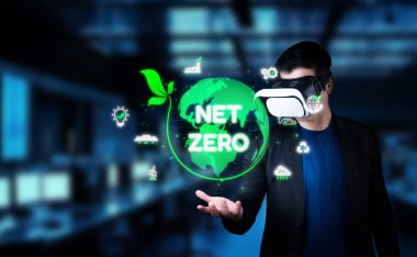 Sanal gerçeklik kulaklığı içinde net sıfır karbon emisyonu kavramlarıyla etkileşime giren bir kişi, iklim değişikliği çözümlerinde yeşil enerjinin ve sürdürülebilirliğin önemini gösteriyor. XDMCP