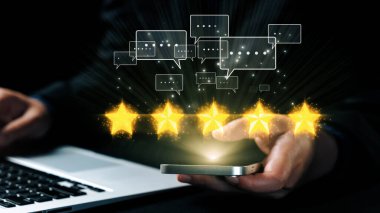 Bir işadamı akıllı telefondan geri bildirim alıyor, beş yıldızlı reytingler ve dijital iletişim baloncuklarını modern çalışma ortamında sergiliyor. Dörtgen