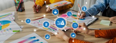 Dinamik bir ekip modern bir ofiste finansal stratejiler üzerinde işbirliği yapar. Renkli çizelgeler ve kavramlar etkin karar verme işlemleri için vergi planlama ve iş analizlerini görselleştirir. Dostluk
