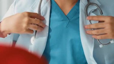 Hasta klinikte ya da hastane ofisinde doktor randevusuna gidiyor. Hastaların nabzını steteskopla kontrol edip risk faktörünü belirleyen doktor semptomları inceliyor. Panorama. Katı.