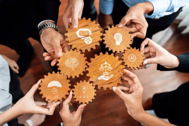 Dinamik bir görüntüde, ahşap dişlilerin her biri ahlak, teknoloji ve yenilik sembolleri içeren ve bir iş ortamında işbirliğini vurgulayan çeşitli eller yer alıyor. Dostluk