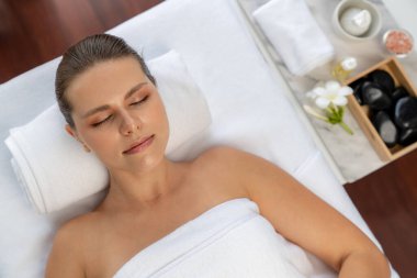 Panorama manzaralı kadın müşteri stres önleyici spa masajından zevk alıyor ve lüks otel veya oteldeki gündüz açık hava ortamında güzellik teniyle eğleniyor. Sessiz.