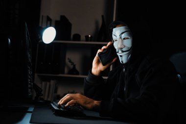 Beyaz gülümseyen isimsiz suçlu maskesi kurbana sesleniyor, kişisel bilgileri hacklemeye ikna ediyor, veri sunucu sistemindeki bilgisayar korsanlarının kullandığı şifreleme programını paylaşıyor. Tahmin et..