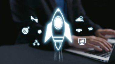 Modern iş ve teknoloji bağlamlarında strateji ve başarıyı temsil eden çeşitli dijital simgeler arasında büyümeyi ve yeniliği sembolize eden parlak bir roket fırlatılır. Dörtgen