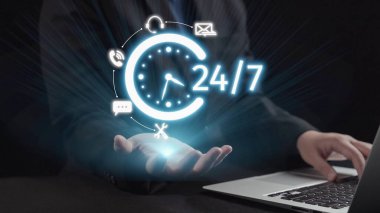 Bu resim, dijital bir saat aracılığıyla 24 saatlik kullanılabilirlik kavramını ve sürekli desteğin önemini gösteren iletişim simgelerini gözler önüne sermektedir. Dörtgen