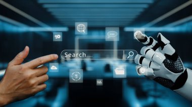 Bir insan eli, parlak bir ofis ortamında arama simgeleri ve iletişim sembolleri gösteren, gelecekteki dijital bir arayüzde robotik bir elle temas kurmak için uzanır. Auvana